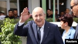 FILE - Algerian President Abdelmadjid Tebboune gestures outside a polling station during the presidential election in Algiers on Sept. 7, 2024.