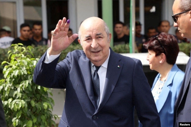 Algerian President and presidential candidate Abdelmadjid Tebboune gestures outside a polling station during the presidential election in Algiers on Sept. 7, 2024. (Algerian Presidency via Reuters)