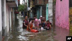 A sick person is rescued from a flooded area following heavy rainfall in Patna, India, Sept.30, 2019. 
