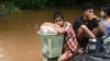 Flood-affected residents wait for a rescue boat to pick them up in Taungoo, Myanmar's Bago region on Sep. 14, 2024, following heavy rains in the aftermath of Typhoon Yagi. 