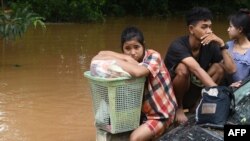 Flood-affected residents wait for a rescue boat to pick them up in Taungoo, Myanmar's Bago region on Sep. 14, 2024, following heavy rains in the aftermath of Typhoon Yagi. 