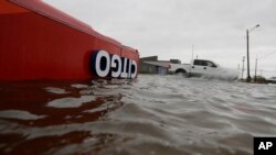 FILE - The roof of a gas station sits in flood waters in the wake of Hurricane Harvey in Aransas Pass, Texas, Aug. 26, 2017. 