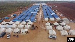 FILE - An aerial view taken on Feb. 22, 2020 shows a newly-created camp for internally displaced people (IDP) near the town of Maarrat Misrin in Syria's Idlib province. 