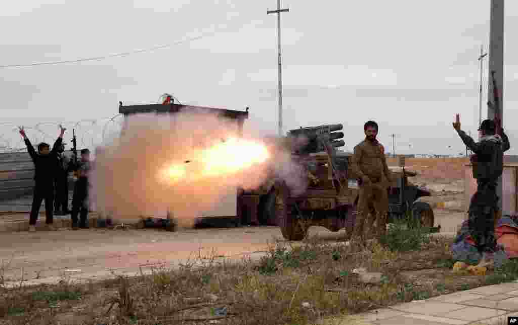 Imam Ali Brigades, members of an Iraqi Shi&#39;ite militant group, launch rockets against Islamic State extremist positions during clashes in Tikrit, 130 kilometers (80 miles) north of Baghdad, Iraq.