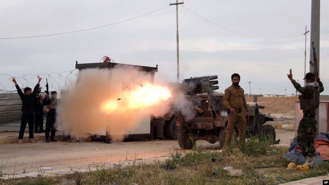 Imam Ali Brigades, members of of an Iraqi Shiite group, launch rockets against Islamic State extremist positions during clashes in Tikrit, 130 kilometers north of Baghdad, Iraq, March 24, 2015.
