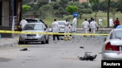 Police forensic experts examine a scene following a vehicle explosion near a military facility in Istanbul, Turkey, May 12, 2016. The blast came two days after PKK rebels detonated a car bomb in the mainly-Kurdish city of Diyarbakir.