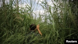 FILE - A U.S. border patrol agent patrols a trail along the Rio Grande river at the border between United States and Mexico, in Roma, Texas.