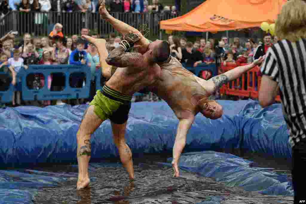 Competitors take part in the 10th annual World Gravy Wrestling Championships held at the Rose 'n' Bowl Pub near Bacup, north west England on August 28, 2017. 