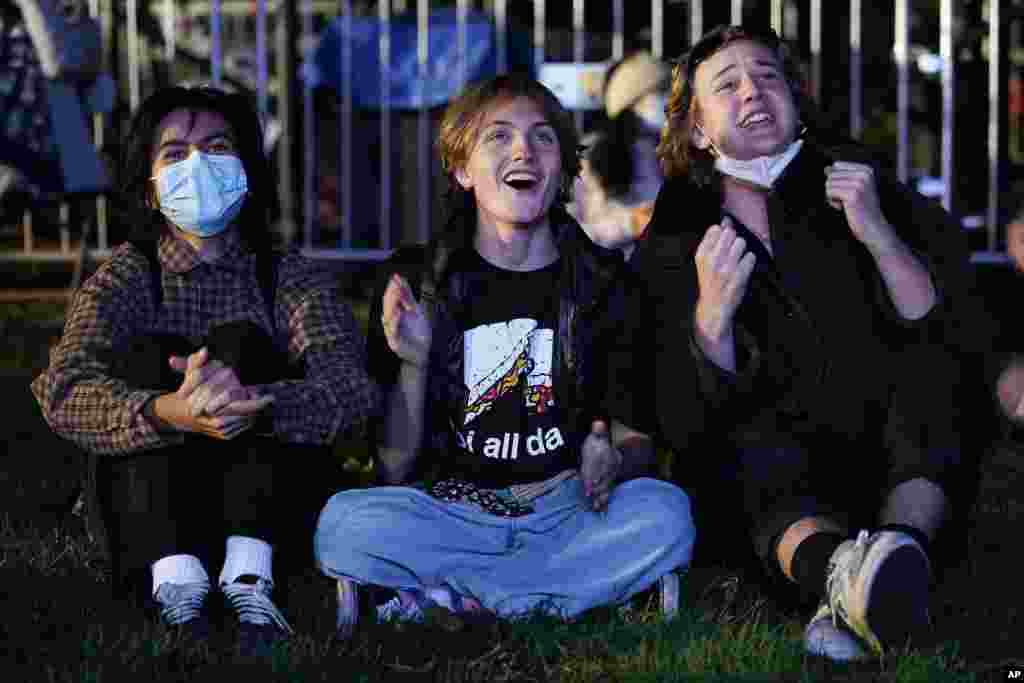 From left: Niki Gotzev, Milo Shea and Ryan Thomas react to local election results in Washington, D.C.