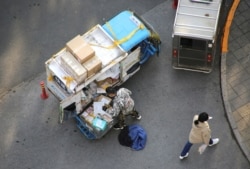 A deliveryman prepares to deliver parcels outside an apartment block after the 11.11 Singles' Day shopping festival in downtown Beijing, China, November 12, 2019. REUTERS/Jason Lee