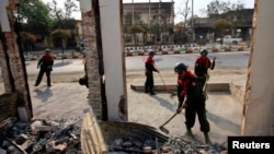 Soldiers work to clean debris in Meikhtila, March 24, 2013, following clashes between Buddhists and Muslims in the city.