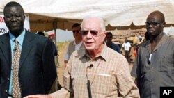 Former US president Jimmy Carter (C) during a press conference in the southern Sudanese village of Lojora , 11 Feb 2010