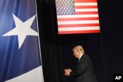 President Donald Trump leaves the stage after his remarks at a Salute to Service charity dinner in conjunction with the PGA Tour's Greenbrier Classic at The Greenbrier in White Sulphur Springs, W.Va., Tuesday, July 3, 2018.