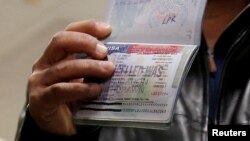 FILE - A Yemeni national who was denied entry into the U.S. shows a canceled visa in his passport, at Washington Dulles International Airport, in Dulles, Virginia, Feb. 6, 2017.