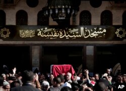 People carry the coffin of Egyptian singer and actress Shadia, during her funeral procession, at the Sayeda Nafisa Mosque in Cairo, Egypt, Wednesday, Nov. 29, 2017.