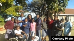 Giving Back! Energy Maburutse from Lynn University speaks with the English Access Class at Chiedza Childcare Centre, Harare, about removing societal stigma for those with disabilities.