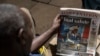 A man looks at a newspaper with the headline of the death of defence chief General Francis Omondi Ogolla and nine other senior military officers who were killed in a helicopter crash, in Nairobi on April 19, 2024.