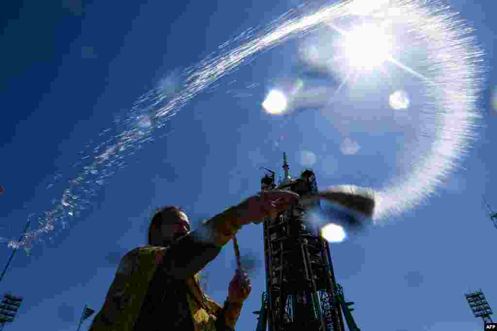 A Russian Orthodox priest blesses the Soyuz MS-13 spacecraft at the launch pad of the Russian-leased Baikonur cosmodrome in Kazakhstan.