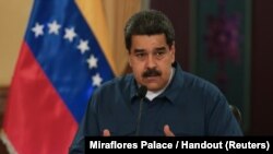 FILE - Venezuela's President Nicolas Maduro speaks during a meeting with ministers at the Miraflores Palace in Caracas, Venezuela, Aug. 13, 2018.