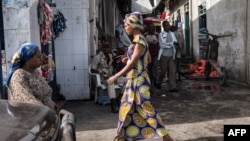 FILE - People walk through the Birere market in Goma, March 26, 2015. 