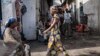 FILE - People walk through the Birere market in Goma, March 26, 2015. 