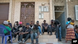 Rappers and musicians in Senegal's Y'en a Marre (We're Fed Up) coalition sit in Dakar while waiting to make a music video. 