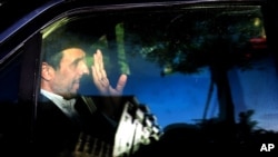 FILE - Former Iranian president Mahmoud Ahmadinejad waves from his car outside his house in northeastern Tehran, Iran, Aug. 3, 2015. 