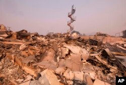 The charred remains of the burned out home are seen in Malibu, Calif., Nov. 10, 2018.