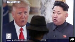 FILE - A man watches a TV screen showing U.S. President Donald Trump, left, and North Korean leader Kim Jong Un during a news program at the Seoul Train Station in Seoul, South Korea, Aug. 10, 2017. 