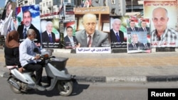A poster depicting Sunni politician Ashraf Rifi (C) is seen among posters of Lebanese candidates that were running in Tripoli's municipal and mayoral elections, Lebanon, May 30, 2016.