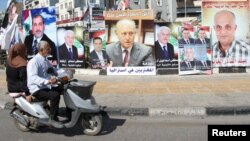 A poster depicting Sunni politician Ashraf Rifi (C) is seen among posters of Lebanese candidates that were running in Tripoli's municipal and mayoral elections, Lebanon, May 30, 2016.