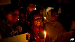 India Acid Attack: FILE - In this Dec. 16, 2014 file photo, acid attack survivors participate in a candlelit vigil protesting violence against women as they mark the second anniversary of the deadly gang rape of a student on a bus, in New Delhi, India. 