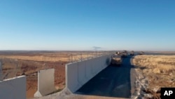 Turkish army armored vehicles arrive at a meeting point near the Turkish town of Idil at the Turkey-Syria border before Turkish and Russian troops conduct their third joint patrols in northeast Syria, Nov. 8, 2019. 