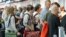 People wait in line at the security checkpoint at the Portland International Airport, July 3, 2012, in Portland, Oregon.