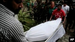 The body of Italian citizen Cesare Tavella, who was gunned down by unidentified assailants, is carried out of a hospital morgue in Dhaka, Bangladesh, Oct. 14, 2015. 