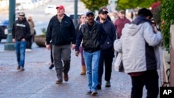 Boeing employees leave after voting on a new contract offer from the company, Nov. 4, 2024, outside the Angel of the Winds Arena in Everett, Wash.