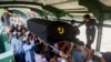 People attend a funeral of U Khin Maung Latt, 58, National League for Democracy (NLD party member in Yangon, Myanmar, March 7, 2021.