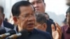 In this photo taken on Feb. 14, 2020, Cambodia's Prime Minister Hun Sen delivers a speech to passengers after they disembarked from the MS Westerdam, owned by Holland America Line, at the port of Sihanoukville, Cambodia.