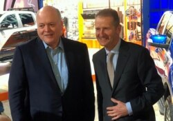 The President and CEO of Ford Motor Company Jim Hackett, poses with Volkswagen CEO Herbert Diess at the North American International Auto Show in Detroit, Jan. 14, 2019.