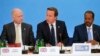 Britain's Prime Minister David Cameron (C) sits with Foreign Secretary William Hague (L) and Somali President Hassan Sheikh Mohamud, as he speaks at the Somalia conference in London, May 7, 2013. 