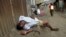 A man sleeps on the streets after drinking distilled traditional alcoholic liquor, locally known as "chang'aa", in the suburbs of Nairobi May 9, 2014