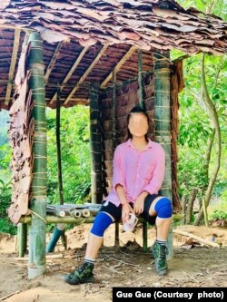 “I never dreamed that I would be sleeping in a roofless shelter or using a makeshift toilet,” said Gue Gue, shown at the toilet she helped build. Source: courtesy of Gue Gue