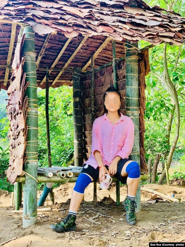 “I never dreamed that I would be sleeping in a roofless shelter or using a makeshift toilet,” said Gue Gue, shown at the toilet she helped build. Source: courtesy of Gue Gue