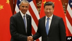 FILE - U.S. President Barack Obama, left, and Chinese President Xi Jinping shake hands at the West Lake State Guest House in Hangzhou, China, Sept. 3, 2016, on the sidelines of the G-20 summit.