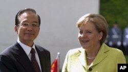 Chinese Prime Minister Wen Jiabao, stands with German Chancellor Angela Merkel. Chinese Prime Minister stays for a two day official visit in Germany, June 28, 2011