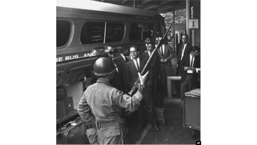 A new busload of "Freedom Riders," including four white college professors and three Negro students, arrives in Montgomery, Alabama, under the protection of police and National Guard in this May 24, 1961, file photo