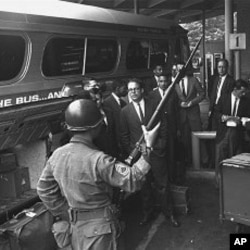 A new busload of "Freedom Riders," including four white college professors and three Negro students, arrives in Montgomery, Alabama, under the protection of police and National Guard in this May 24, 1961, file photo