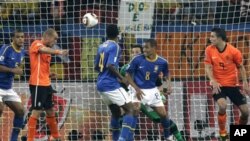 Netherlands' Wesley Sneijder, second from left, scores a goal.