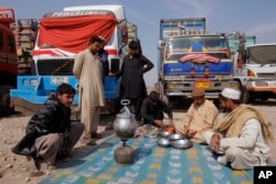 Drivers of Afghanistan-bound trucks wait for the opening of Pakistan Afghanistan border outside Peshawar, Pakistan, Tuesday, March 14, 2017. The closure of the border between Pakistan and Afghanistan, blamed on deteriorating relations, is more than inconv