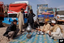 Drivers of Afghanistan-bound trucks wait for the opening of Pakistan Afghanistan border outside Peshawar, Pakistan, March 14, 2017.